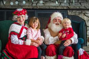 Santa and Mrs. Clause sitting in front of a warm fireplace at Beech Mountain Resort.