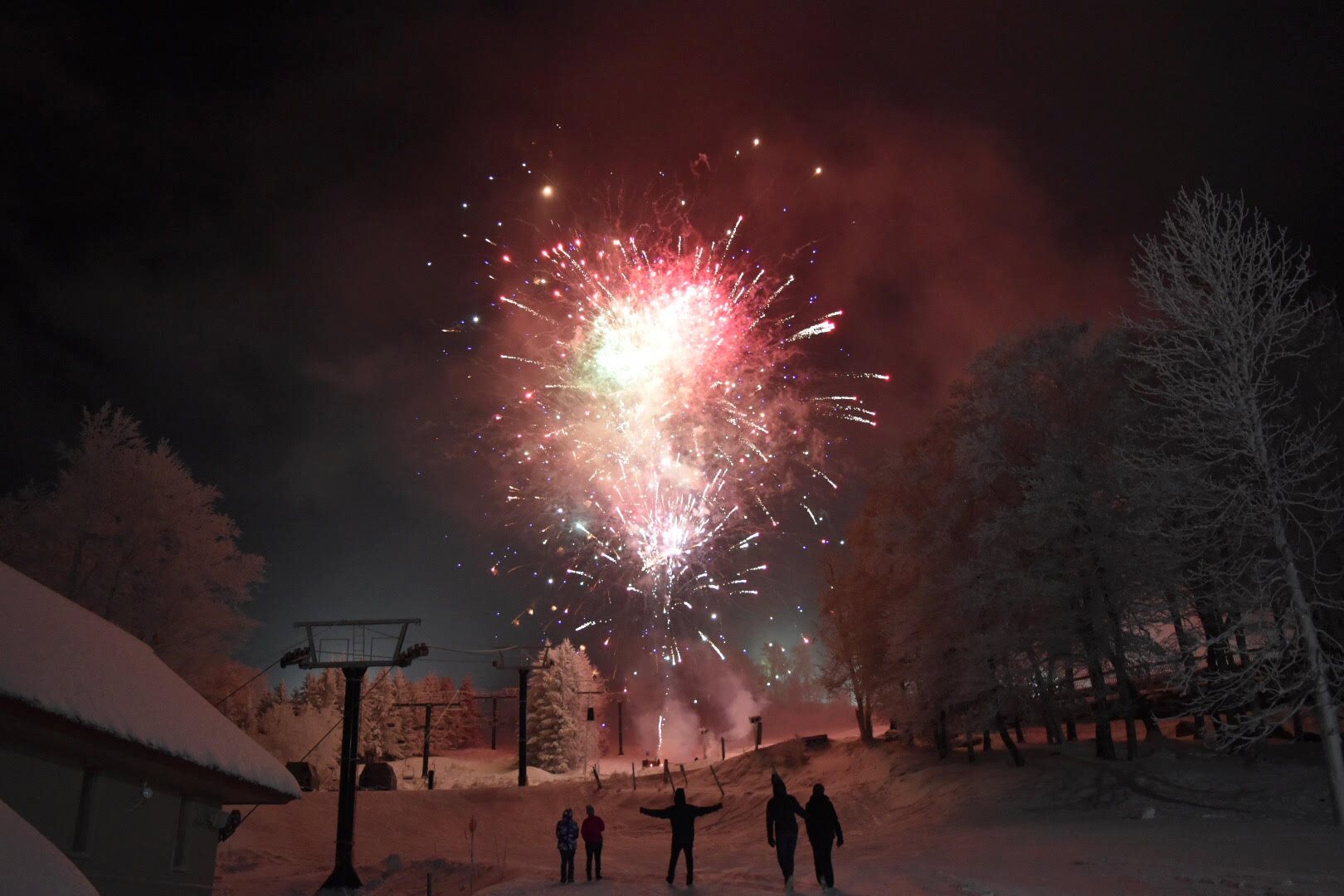 colorful fireworks blast off the slopes