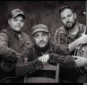 Black and white photo of Craig Street band members together with one in the middle front of the other two on each side