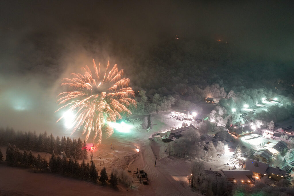 Fireworks display over a snow covered Beech Mountain Ski Resort