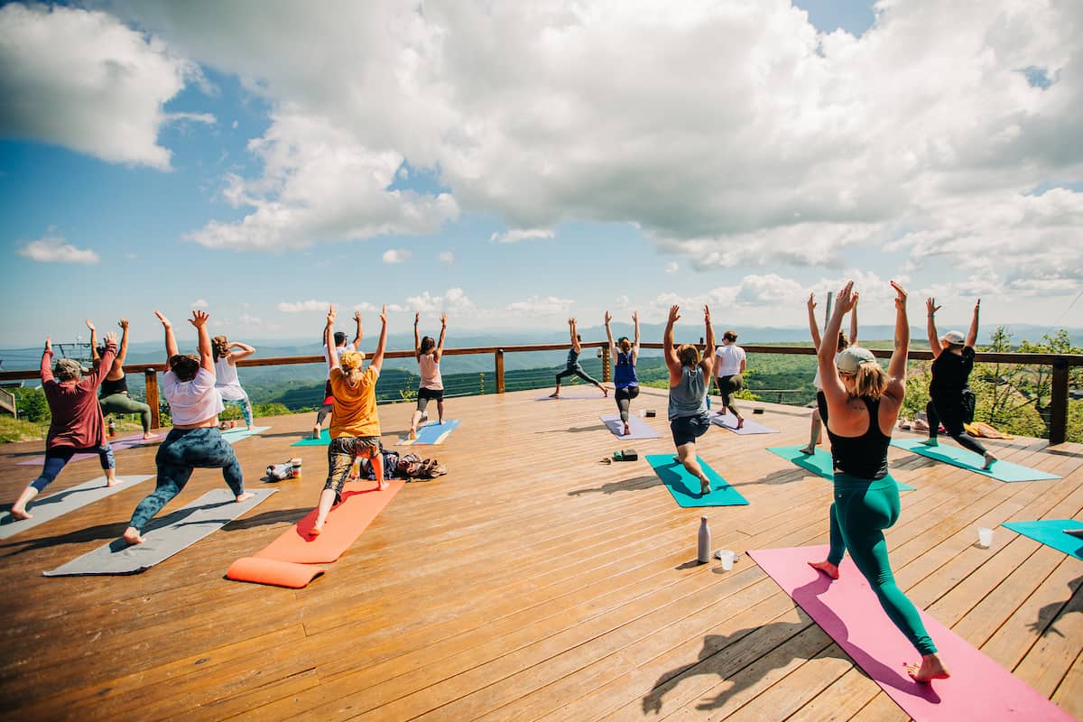 a wide shot of the entire yoga class on a beautiful day at the high top bar