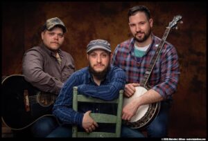 3 men in a band sitting down