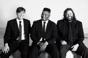 Reggie Sullivan Band, Three men sitting in black and white with suits.